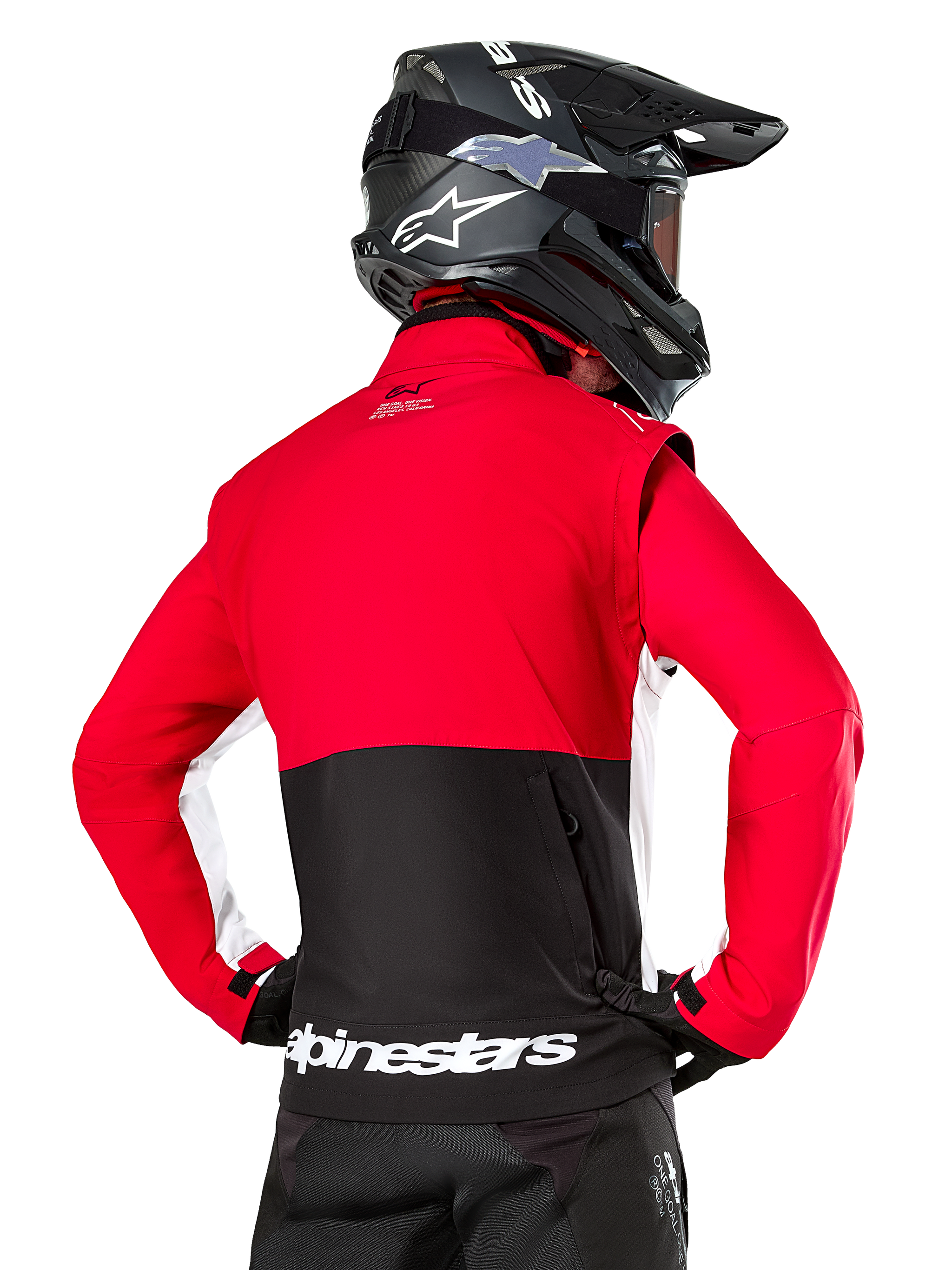 Alpinestars Lite-Dura Softshell Jacket, Black Bright Red White, back view on a motocross rider, red upper body and sleeves with black lower back panel, zippered rear storage pocket, white Alpinestars logo on the bottom hem, worn with a black helmet and pants