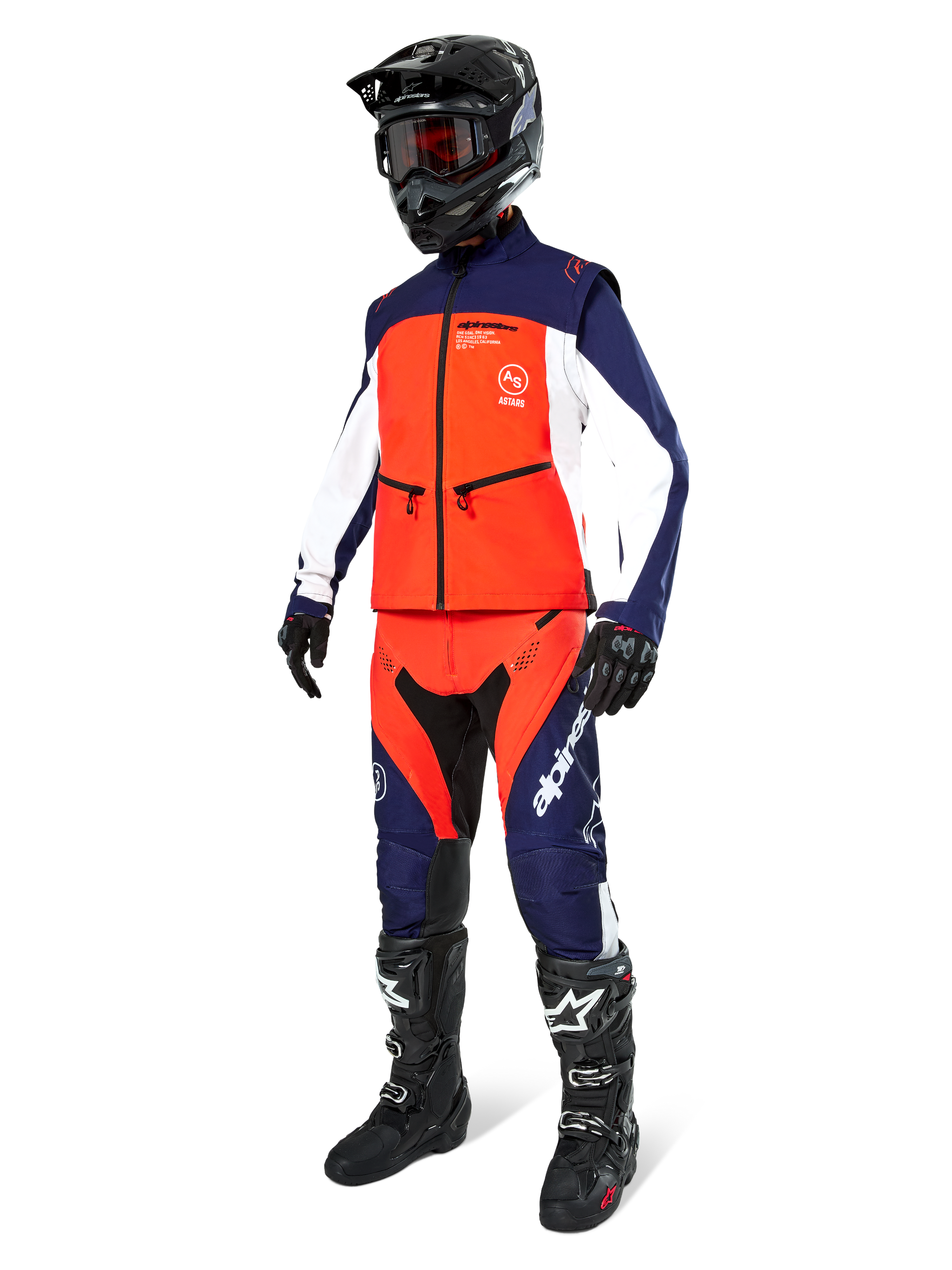 Motocross rider wearing the Alpinestars Lite-Dura Softshell Jacket in Navy Hot Orange and White, complete with matching off-road pants, black helmet with goggles, and black racing boots, coordinated enduro gear set