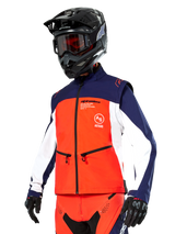 Alpinestars Lite-Dura Softshell Jacket in Navy, Hot Orange, and White, Motocross Gear, worn with black helmet and goggles, protective gloves, and matching racing pants