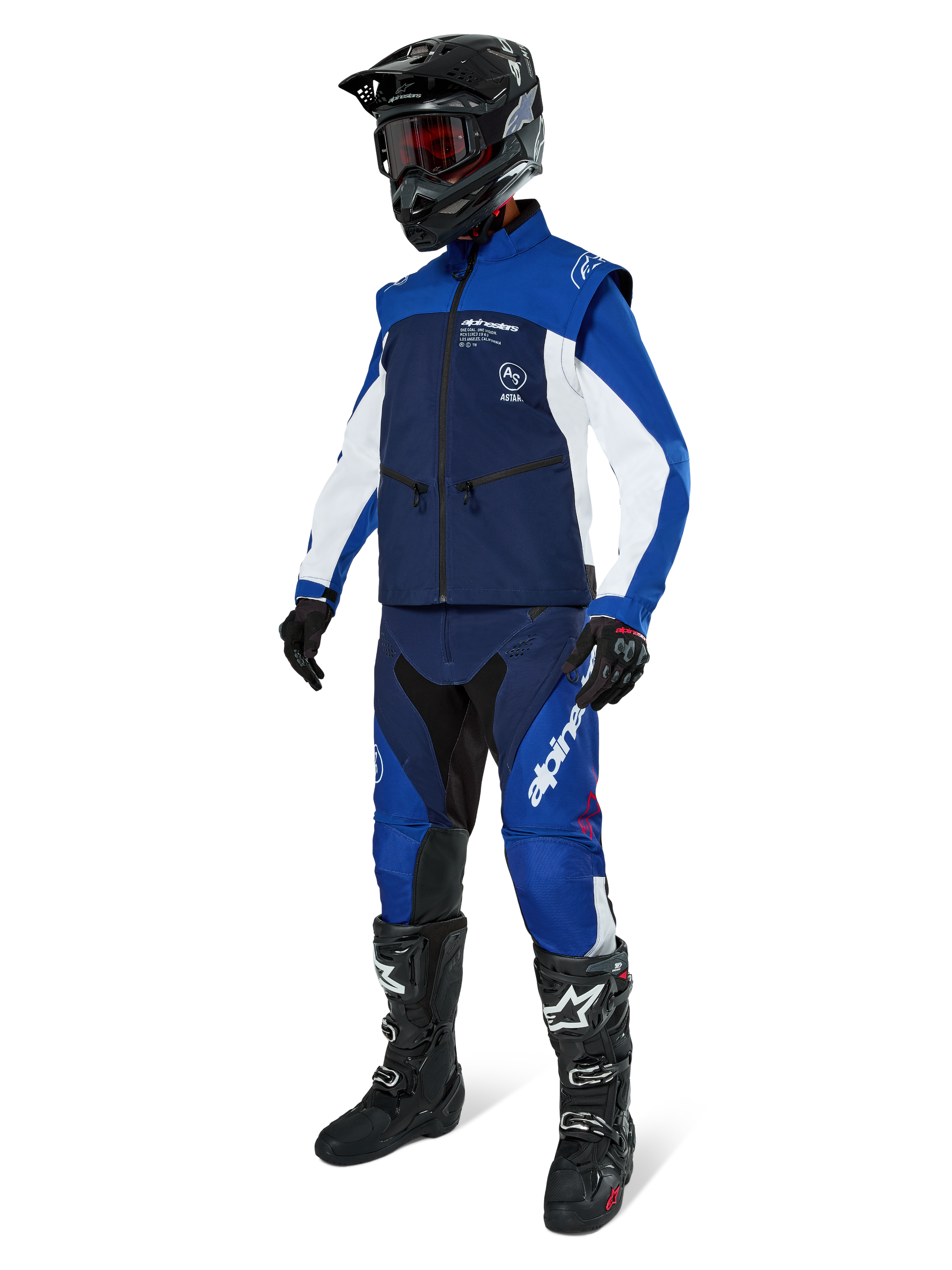 Alpinestars Lite-Dura Softshell Jacket, Navy Bright Blue and White, worn with matching off-road pants, black motocross boots, black helmet with goggles, and black gloves, complete enduro gear for off-road racing