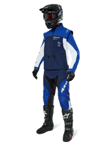 Alpinestars Lite-Dura Softshell Jacket, Navy Bright Blue and White, worn with matching off-road pants, black motocross boots, black helmet with goggles, and black gloves, complete enduro gear for off-road racing