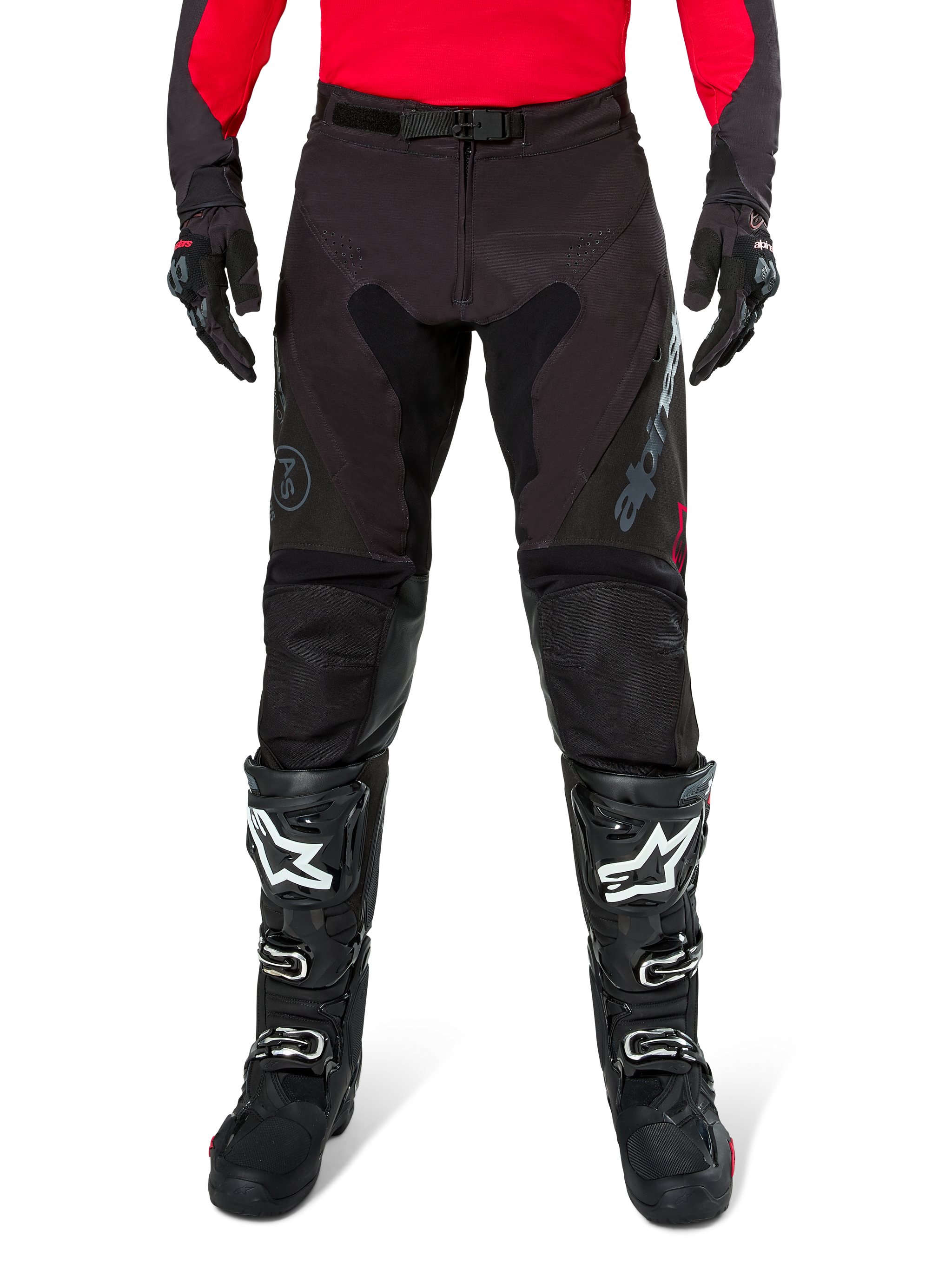 Alpinestars Pro-Dura Pants, Black and Magnet Enduro Pants, worn with a red long-sleeve jersey and black motocross boots, featuring gray Alpinestars branding and durable ripstop construction for off-road riding