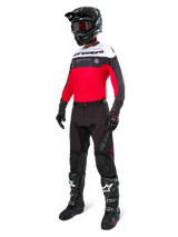 Alpinestars Pro-Dura Pants in Black Magnet White, worn by a rider with a matching red, black and white jersey, black helmet, and black off-road boots, complete professional enduro racing gear set for off-road performance.