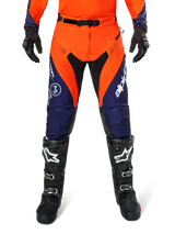 Alpinestars Pro-Dura Pants, Motocross and Enduro Pants, Navy Hot Orange and White, featuring black panels and white logos, worn with black off-road boots and gloves, professional protective gear for trail and off-road riding