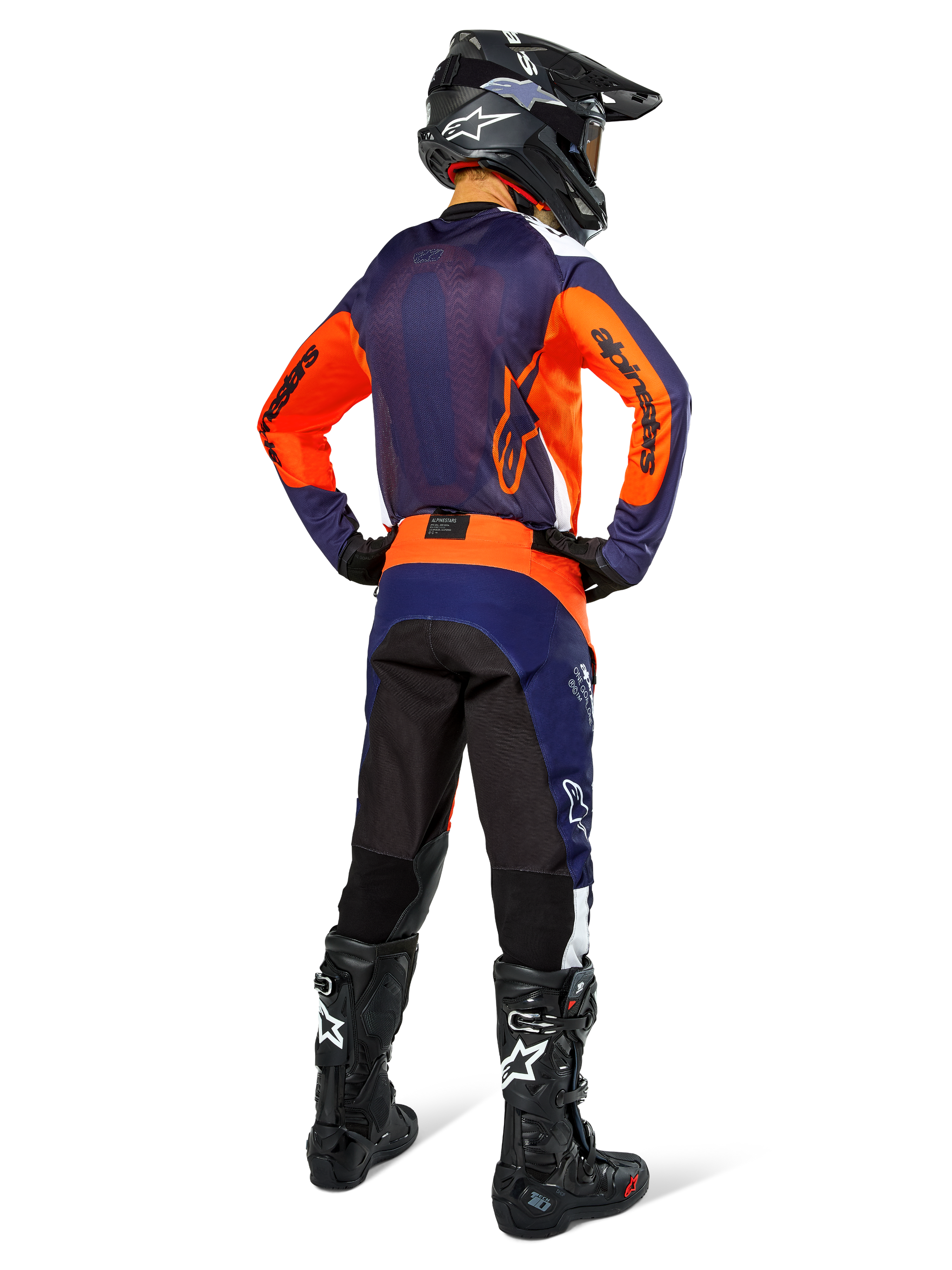 Motocross rider wearing complete racing gear from the back, Navy and orange jersey, Pro-Dura Pants in Navy Hot Orange White, black helmet and black boots, professional off-road racing outfit ensemble.