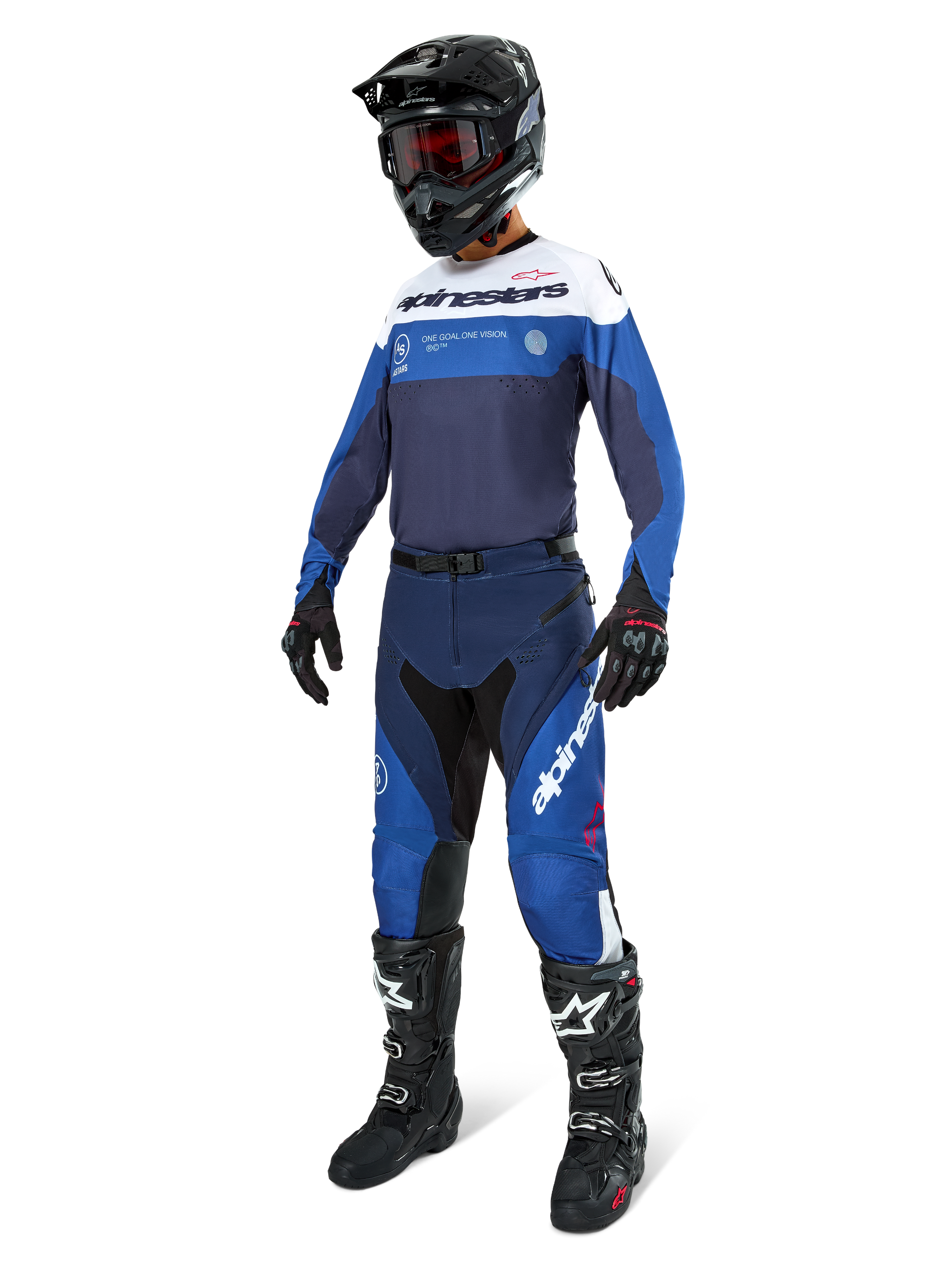 Motocross rider wearing Alpinestars Pro-Dura Pants in Navy, Bright Blue, and White, paired with a matching long-sleeve jersey, black helmet with red goggles, black gloves, and black and white boots, coordinated outfit for enduro and off-road racing.