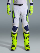 Alpinestars 2026 Racer Air Riway Pants, Motocross Pants, Light Gray Yellow Fluo and Blue, worn with matching neon yellow gloves and boots, featuring perforated front panels for airflow and bold blue and yellow branding, athletic design for off-road performance