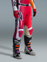 Alpinestars 2026 Racer Portl Pants, Motocross Pants, Red Light Gray and Dark Gray, worn with matching red gloves and multi-colored motocross boots, featuring bold Alpinestars logos and reinforced panels for off-road racing.