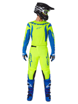 Alpinestars 2025 Fluid Haul Pants, Motocross Pants, Fluorescent Yellow and Blue, worn as a complete racing kit with matching jersey, blue boots, and black helmet, featuring bold blue branding on the thighs and black knee panels