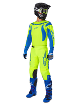 Alpinestars 2025 Fluid Haul Pants, Motocross Pants, Bright Yellow Fluo and Blue, worn as part of a complete racing gear set with matching jersey, blue boots, and a black helmet, high-visibility design for off-road riding.
