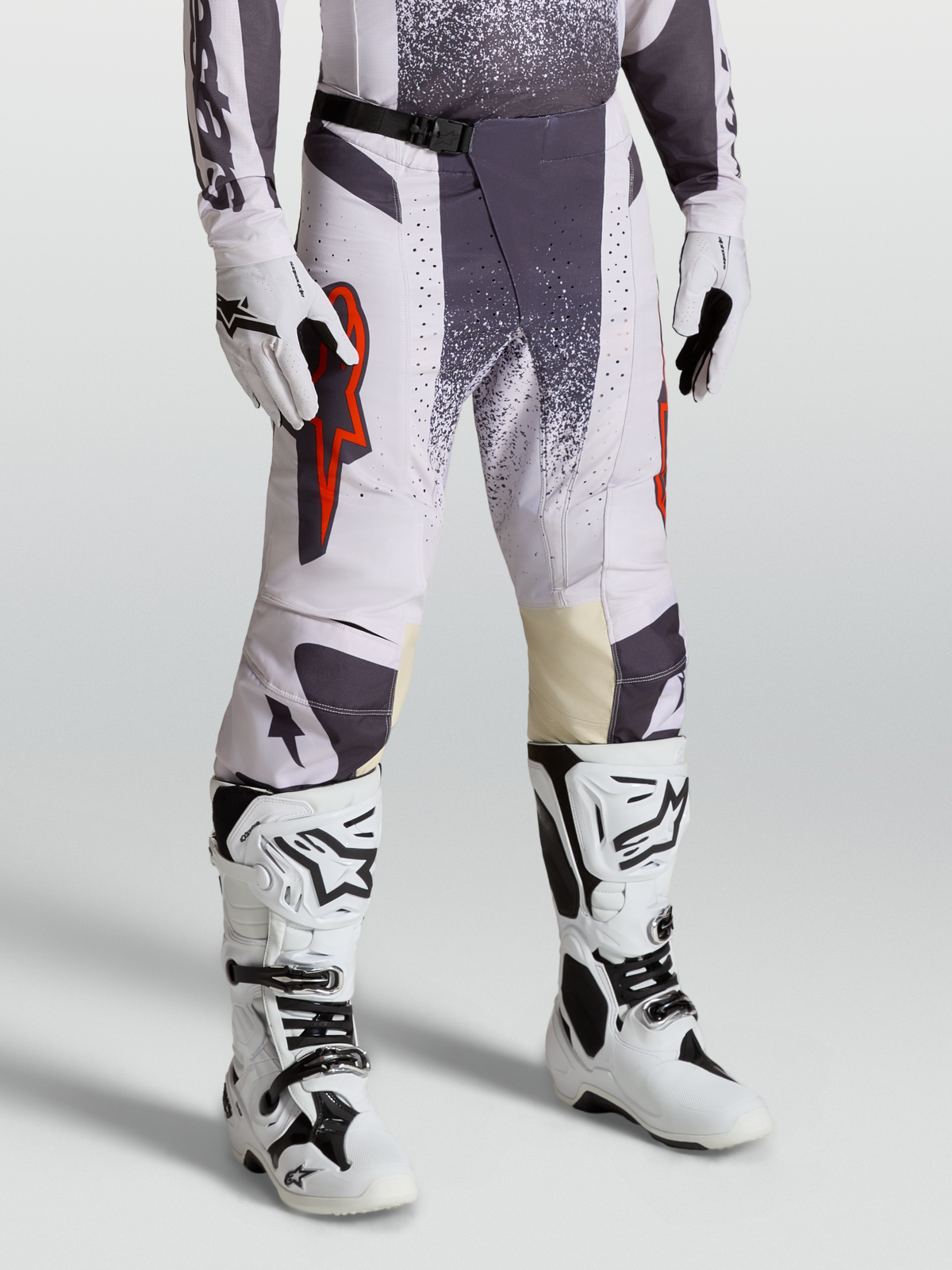 Alpinestars Techstar Swan Pants, Motocross Racing Pants for Men, Light Lilac and Dark Gray with Red Fluo accents, on-model shot with gloves and boots.