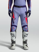Alpinestars Racer Air Hunt Motocross Pants in light violet and deep purple with pink fluo accents, worn with white boots.