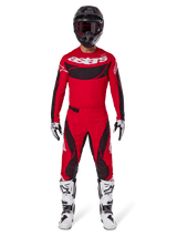 Alpinestars 2025 Techstar Dreem Pants, Motocross Pants, Bright Red and Black, worn as part of a complete racing gear set with a matching red jersey, black helmet, and white boots, sporty design with bold branding for off-road performance.