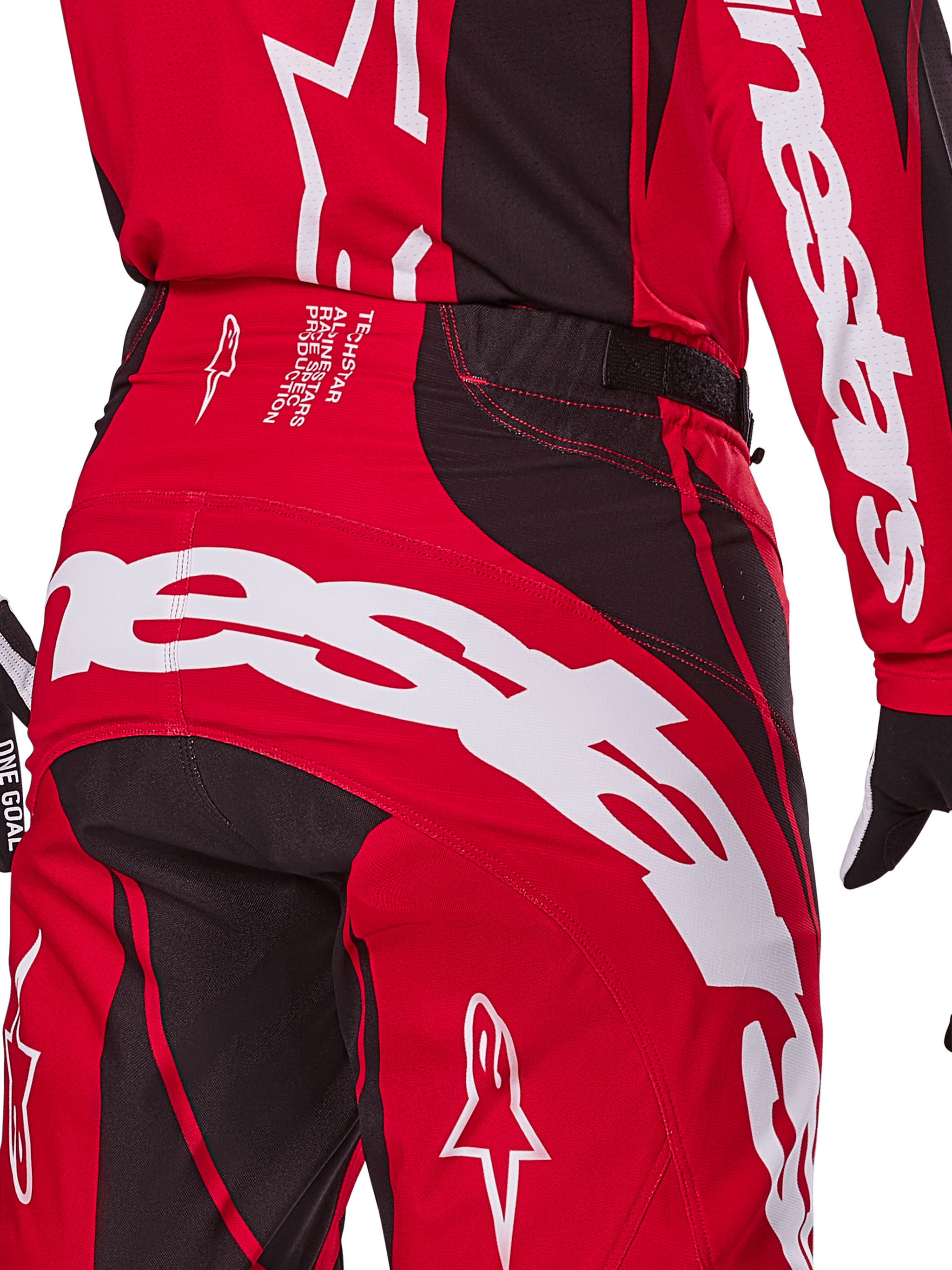 Alpinestars 2025 Techstar Dreem Pants, Motocross Pants, Bright Red and Black, close-up of the rear waist and seat area featuring bold white Alpinestars branding, black stretch panels, and technical production text on the waistband, designed for off-road racing performance.