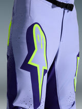 Alpinestars 2026 Supertech Scenz Pants, Motocross Pants, Purple Yellow Fluo, close-up featuring large yellow logo on the thigh, laser-cut perforations for ventilation, and magnetic waist buckle, athletic-fit off-road gear