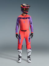 Alpinestars 2026 Supertech Scenz Pants, Motocross Pants, Hot Coral and Purple, worn as a complete gear set with matching jersey and helmet, white and black boots, featuring purple logos and athletic racing fit.