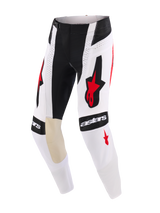 Alpinestars 2026 Techstar Knif Pants, Motocross Pants, White Black and Red, featuring bold Alpinestars logos on the thighs and knees, tan goat leather inner knee panels, perforated details for airflow, and a durable racing design for off-road competition.
