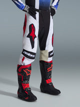 Alpinestars 2026 Techstar Knif Pants, Motocross Pants, Black White and Red, worn with black and red motocross boots, featuring bold Astars branding on the thighs, athletic race fit, and durable multi-panel construction for off-road racing.