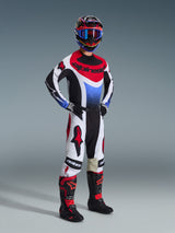 Alpinestars 2026 Techstar Knif Pants, Motocross Pants, Black White and Red, worn by a rider in full racing gear with matching jersey and boots, featuring bold red Alpinestars logos on white panels and a performance-oriented athletic fit.