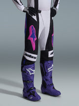 Alpinestars 2026 Techstar Knif Pants, Black Light Gray and Purple, worn with matching purple motocross boots, featuring bold pink accents and 'astars' branding, professional motocross racing gear