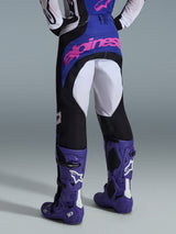 Alpinestars 2026 Techstar Knif Pants, Motocross Pants, Black Light Gray and Purple, rear view featuring pink branding on the seat, worn with matching jersey and purple motocross boots, professional off-road racing outfit