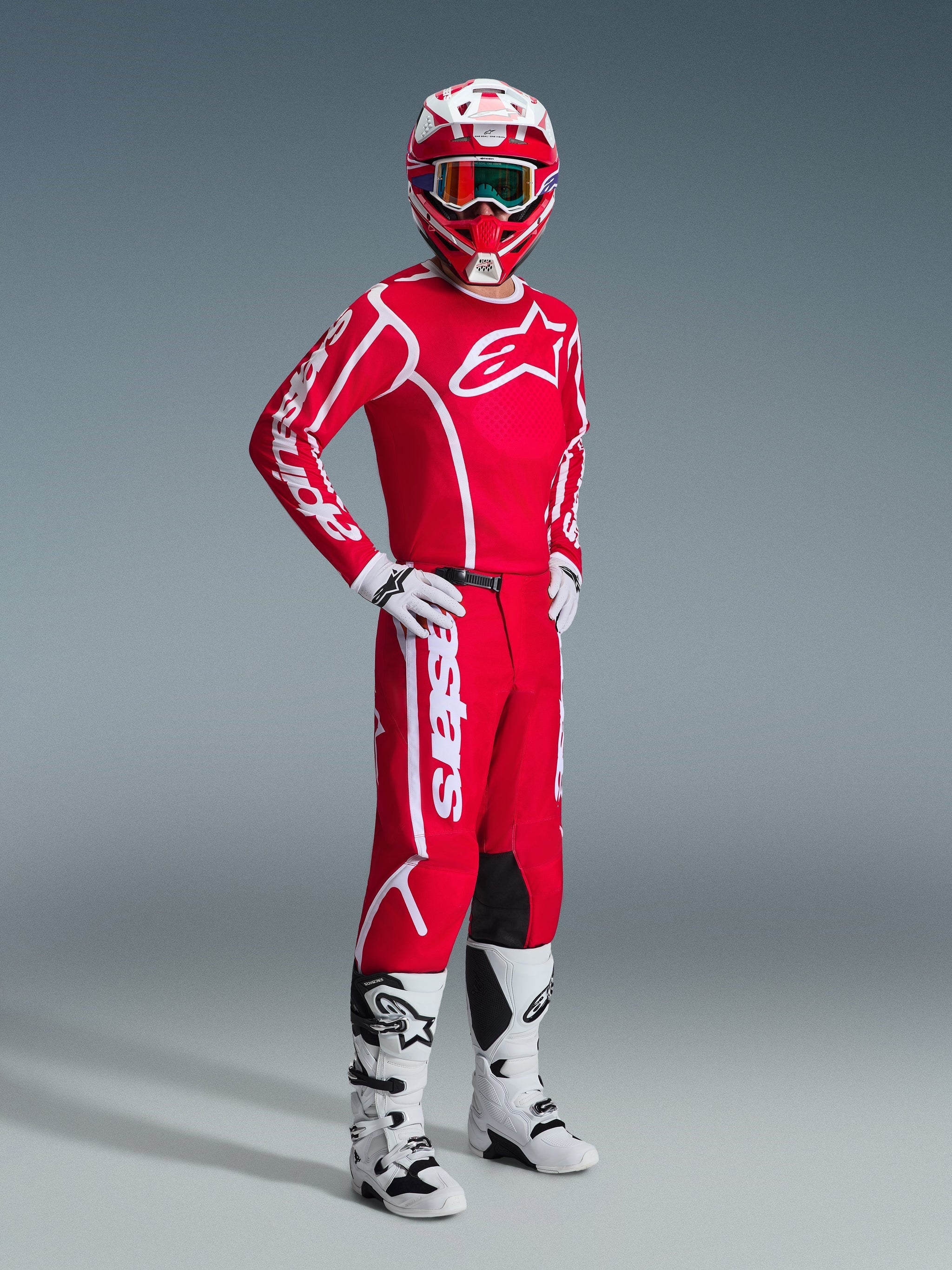 Alpinestars 2026 Fluid Apex Pants, Motocross Pants, Red and White, worn as part of a complete racing gear set with matching jersey, helmet, white boots, and gloves, coordinated outfit for off-road racing