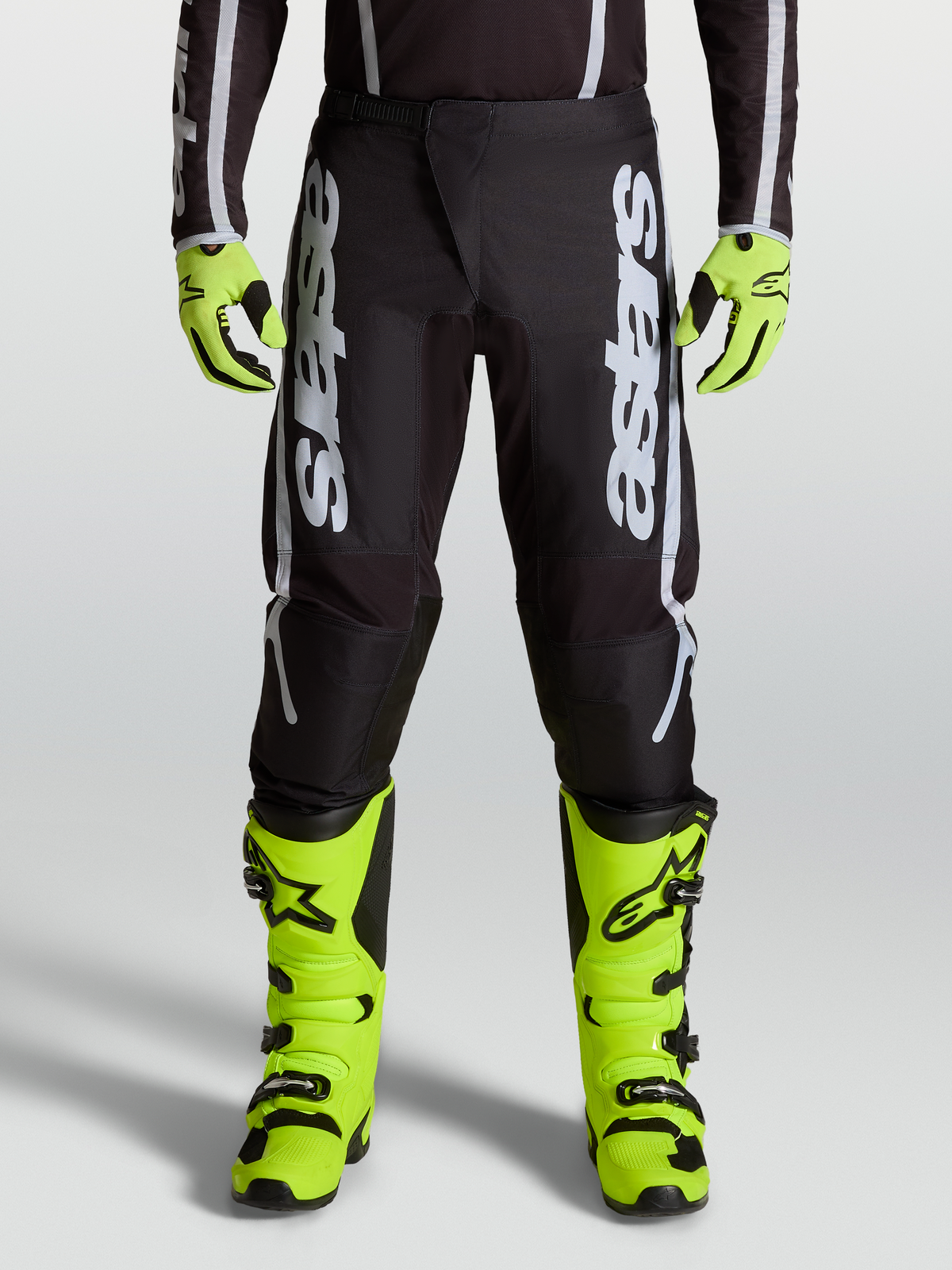 Alpinestars Fluid Apex V2 Pants, professional motocross performance pants in Black and Silver with ergonomic stretch panels.