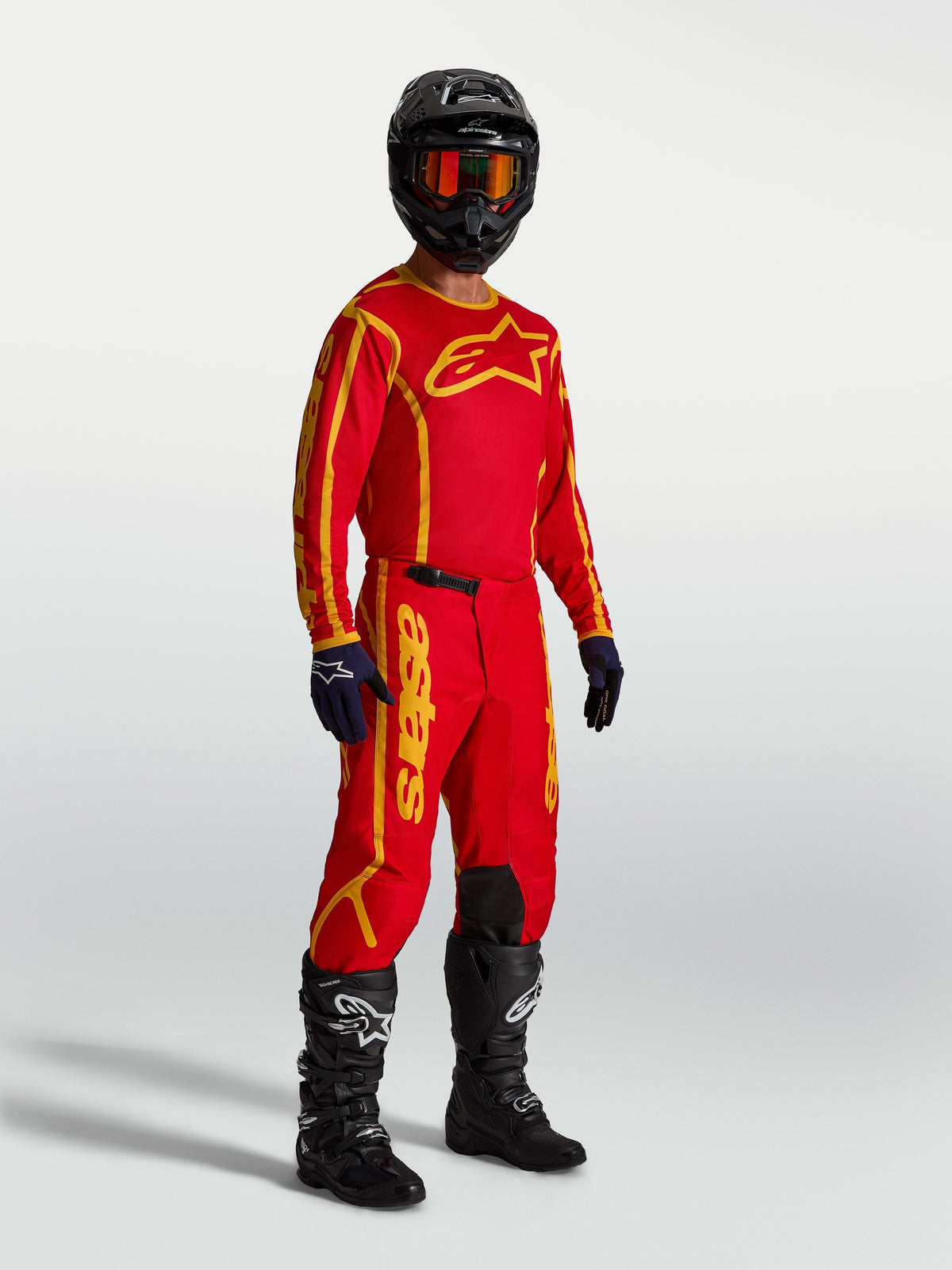 Alpinestars Fluid Apex V2 Pants, Motocross Gear, Fire Red and Gold, on-model with jersey and boots for off-road performance.