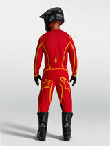 Alpinestars Fluid Apex V2 Motocross Pants in Fire Red and Gold, featuring reinforced seat and ergonomic sport fit.