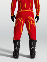 Alpinestars Fluid Apex V2 Pants, Men's Motocross Pants in Fire Red and Gold, Rear View with Black Boots.