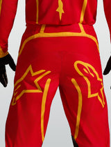 Alpinestars Fluid Apex V2 Pants, Motocross performance gear, Red and Gold, featuring reinforced back yoke and star graphics.