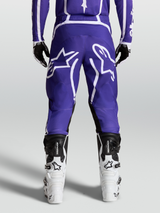 Alpinestars Fluid Apex V2 Pants, Men's Motocross and Off-Road Riding Pants, Deep Blue and White, durable 600D polyfabric and pre-curved leg design shown from the rear on model with boots.