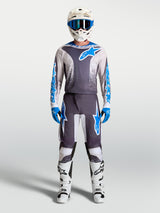 Alpinestars Fluid Drag Pants, Men's Motocross Gear Set in Gray and Blue with matching jersey and white boots.