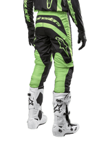 Alpinestars 2024 Fluid Lurv Motocross Pants, Black and Yellow Fluo, rear view featuring ergonomic cut and white boots.