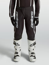 Alpinestars Youth Fluid Apex V2 Motocross Pants, Black and Silver, durable 600D polyfabric with ergonomic pre-curved legs.