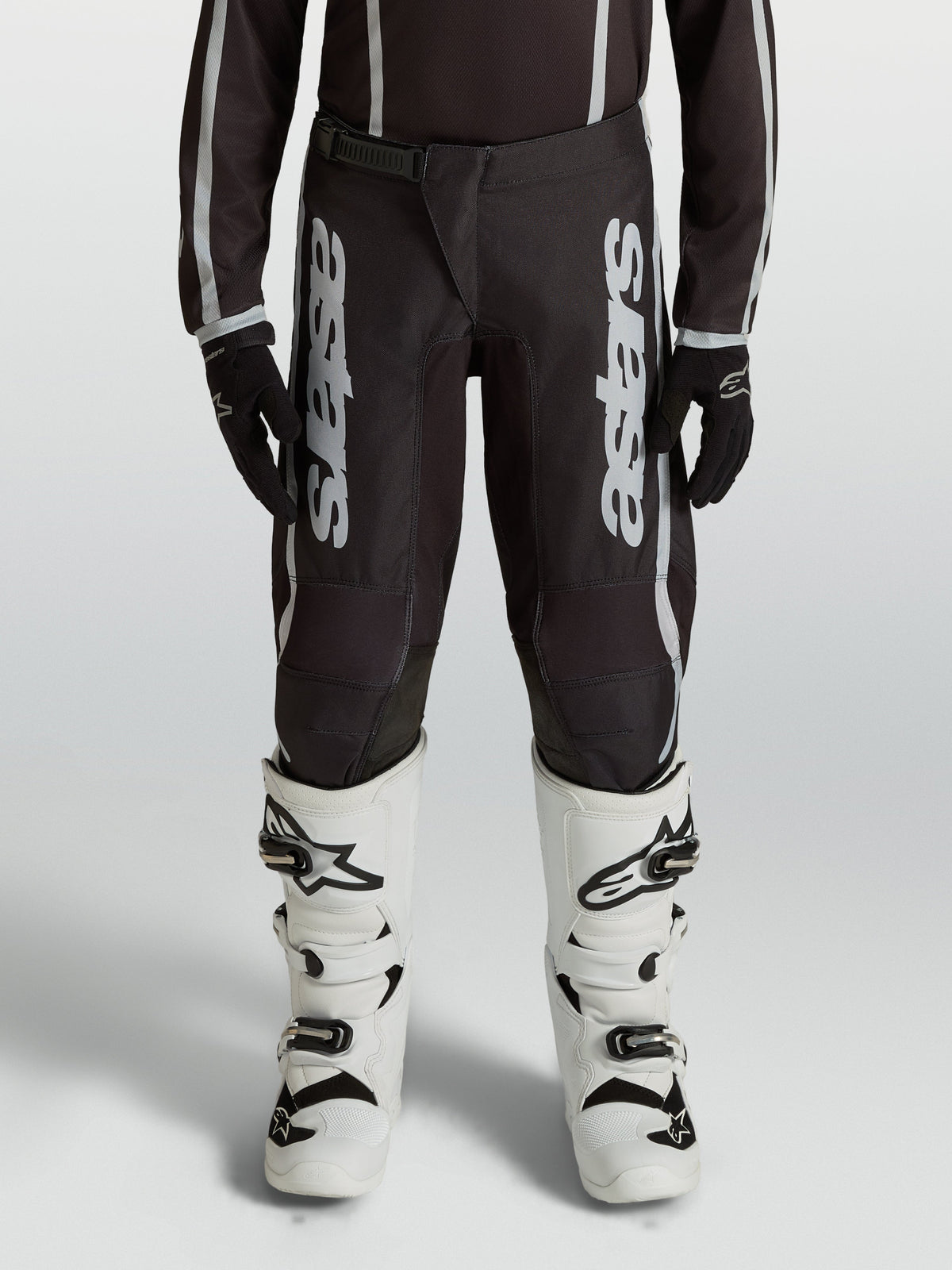 Alpinestars Youth Fluid Apex V2 Motocross Pants, Black and Silver, durable 600D polyfabric with ergonomic pre-curved legs.