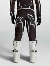 Alpinestars Youth Fluid Apex V2 Pants, black and silver motocross racing gear with ergonomic rear fit and star logos.