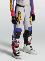 Alpinestars Youth Fluid Drag Pants, blue and lilac youth motocross pants with gold graphics and ergonomic pre-curved design.