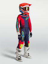 Alpinestars Youth Fluid Drag Pants in blue navy and red, worn as part of a complete motocross racing outfit.