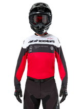 Alpinestars Pro-Dura Jersey, Motocross Jersey, Black Bright Red and White, worn with black helmet and goggles, sporty design with bold Alpinestars branding and laser perforations, performance enduro and off-road racing gear