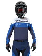 Alpinestars Pro-Dura Jersey, Motocross and Enduro Jersey, Navy, Bright Blue, and White, worn with matching navy pants, black gloves and helmet, featuring chest branding and laser-cut ventilation for off-road motorcycle racing