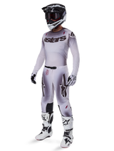 Motocross rider wearing complete racing gear, grey and white gradient jersey with black 'astars' branding, matching pants with red accents and star logos, black and white helmet with dark goggles, white Alpinestars Tech 10 Boots, professional off-road racing outfit