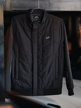 Alpinestars Precedent Jacket, Quilted Sportswear Jacket, Black, featuring an angled quilt pattern, low track collar with covered zipper, chest logo patch, and ribbed cuffs and hem, motorsport-inspired design