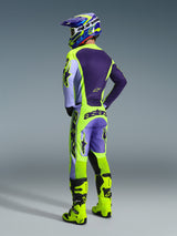 Motocross rider wearing Alpinestars 2026 Racer Portl Jersey and pants, Purple and Yellow Fluo gear set, back view featuring matching helmet and neon yellow boots, coordinated professional off-road racing outfit.