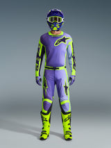 Alpinestars 2026 Racer Portl Jersey, Purple and Yellow Fluo, worn as part of a complete motocross gear set with matching pants, helmet, and bright neon yellow boots, professional off-road racing outfit.