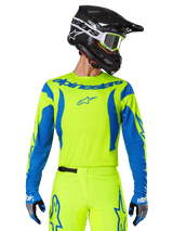 Alpinestars 2025 Fluid Haul Jersey, Motocross Jersey, Neon Yellow and Blue, featuring blue Alpinestars branding on the chest, worn with matching gear including a black helmet and blue gloves, athletic fit for off-road riding