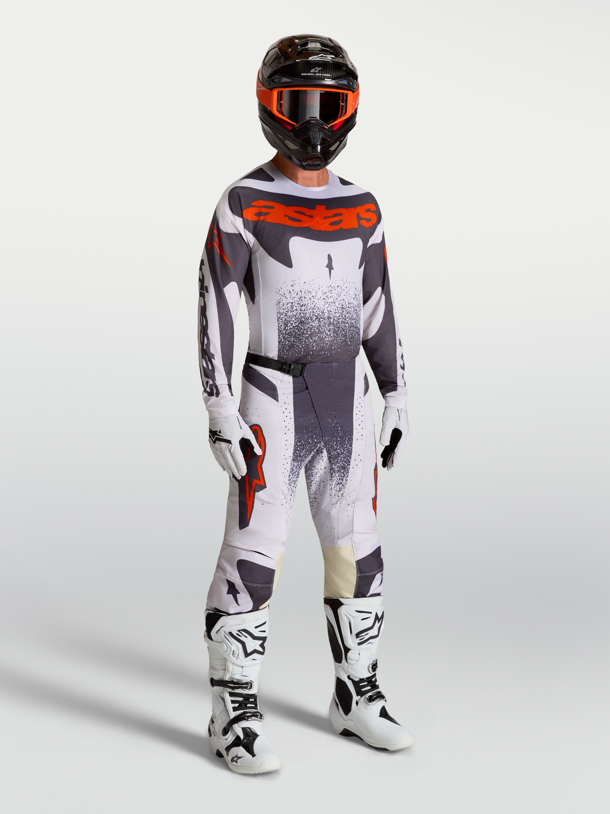 Alpinestars 2027 Techstar Swan Gear Set, professional motocross racing outfit in light lilac, dark gray, and red fluo on a model with white boots and helmet.