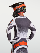 Alpinestars Techstar Swan Jersey, athletic race-fit motocross jersey in Dark Gray and White with Red highlights, shown on rider.