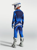 Alpinestars Techstar Swan Motocross Gear Set, athletic race fit, Blue and Deep Blue, featuring white boots and helmet.