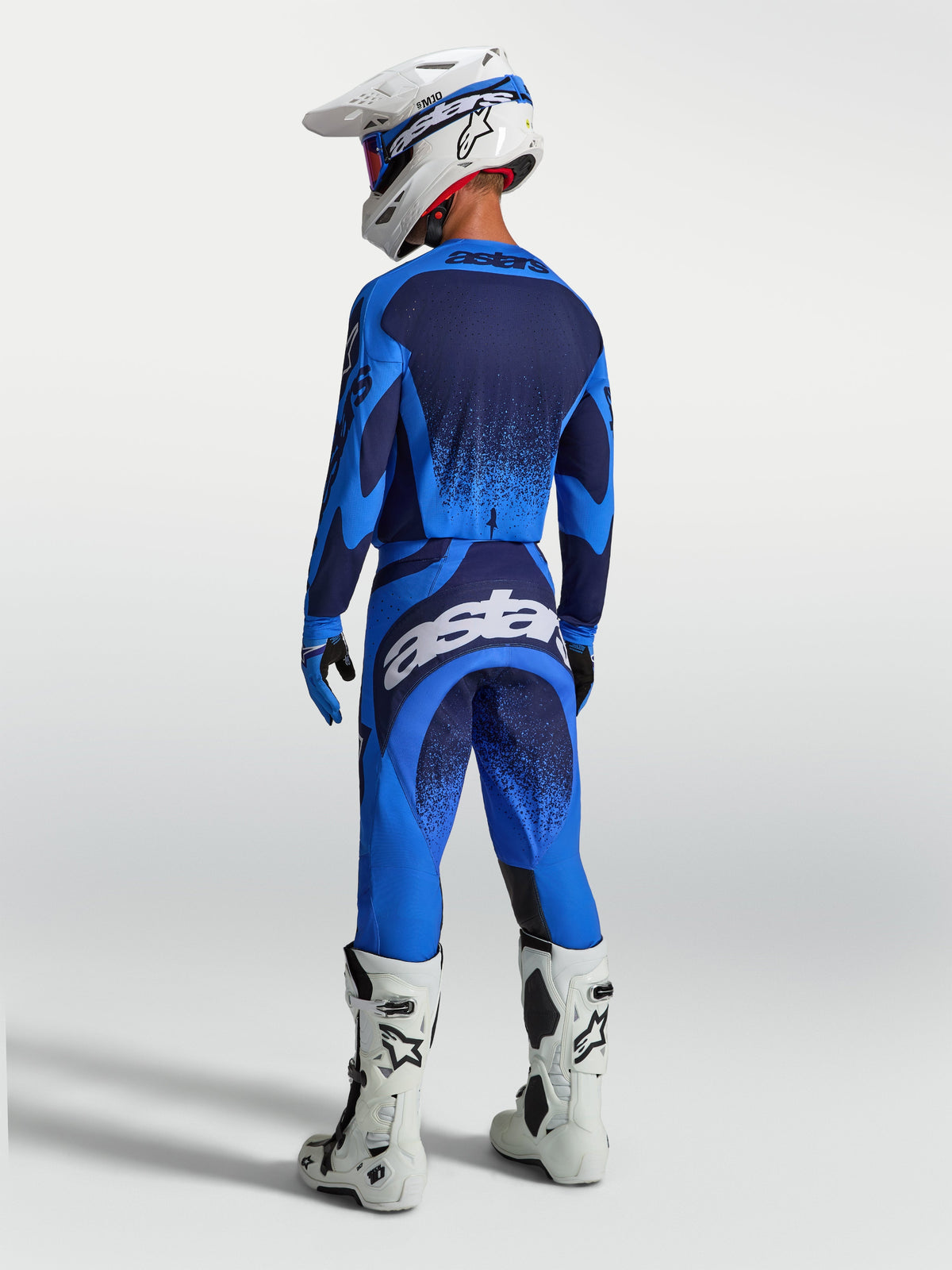 Alpinestars Techstar Swan Motocross Gear Set, athletic race fit, Blue and Deep Blue, featuring white boots and helmet.